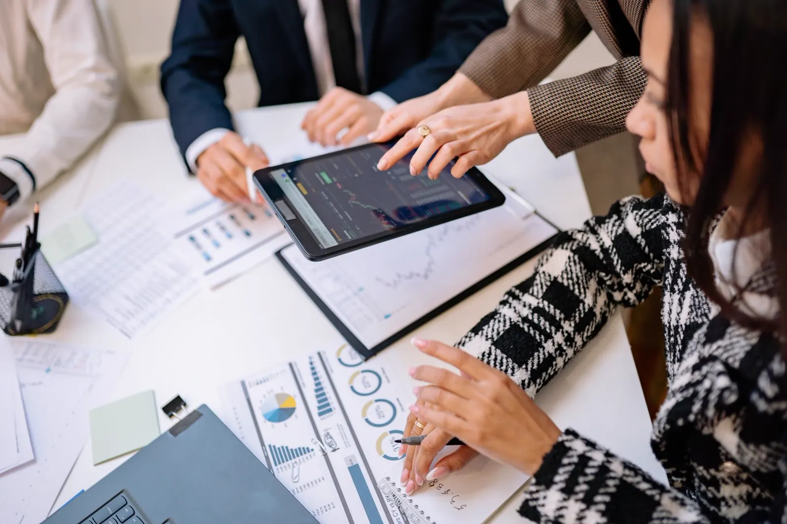 A team reviews results charts on a tablet